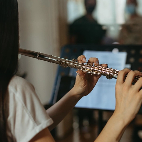 A woman practicing and instrument By Music School In Oak Park.