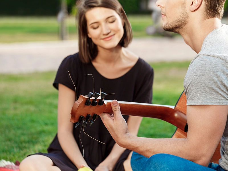 A man and woman enjoying playing and listening to the music.