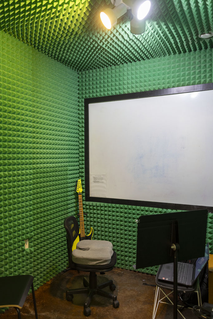 Soundproof guitar lesson room with whiteboard at St John Music in San Antonio