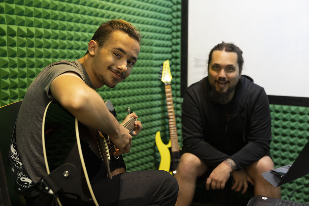 Student taking private guitar lesson at St John Music in San Antonio